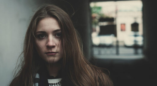 Image of a young girl outside looking directly into the camera