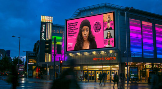 Image shows video call background displayed on large screen outside