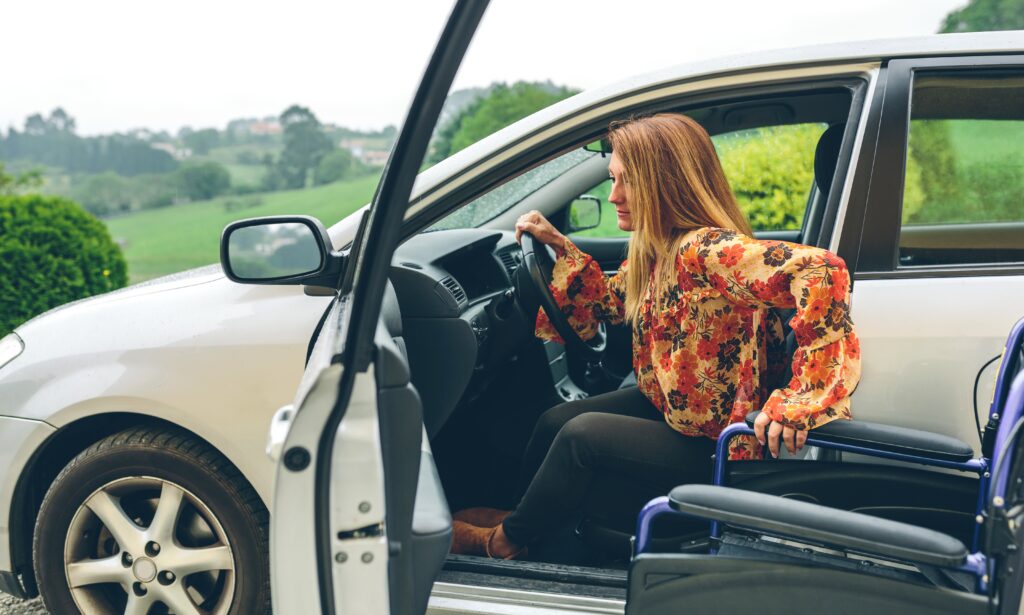 Young woman in a wheelchair leaving the car