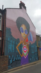 Photo of wall mural depicting Olive Morris holding a megaphone