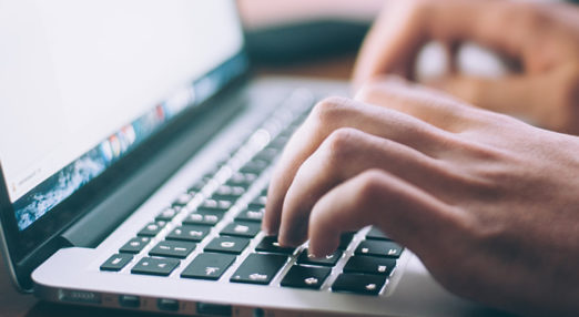 hands typing on keyboard