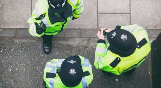 birds eye view photos of three police officers wearing high vis and helmets