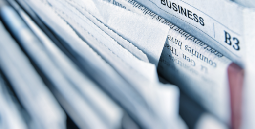 A close up of a stack of newspapers