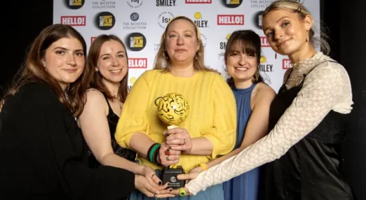 Refuge staff at the Smiley Film Awards holding the trophy